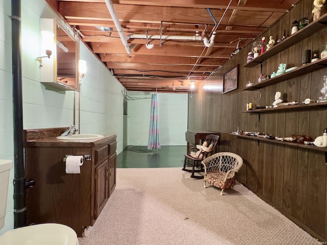 interior space featuring a sink and concrete block wall