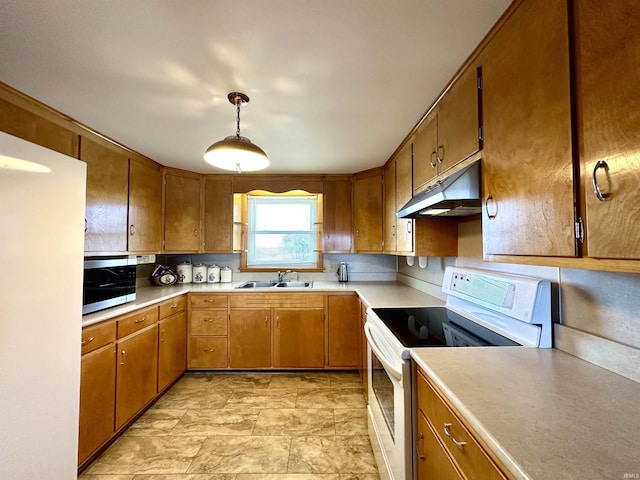 kitchen with white electric stove, under cabinet range hood, a sink, light countertops, and stainless steel microwave