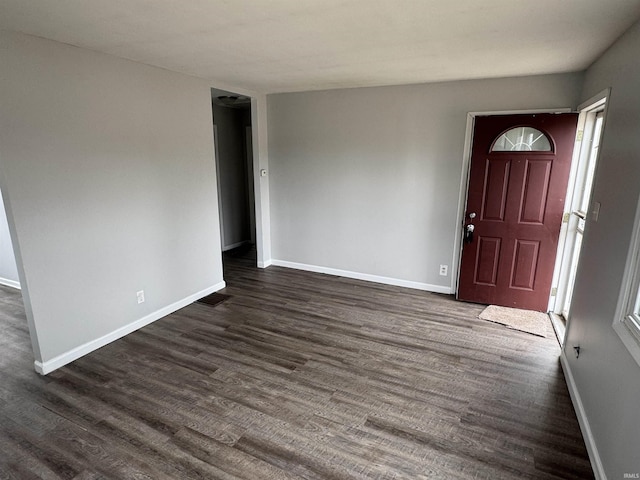 entryway featuring dark wood-type flooring and baseboards