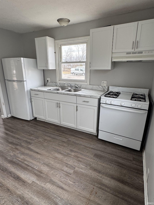 kitchen featuring white cabinets, under cabinet range hood, white appliances, and a sink