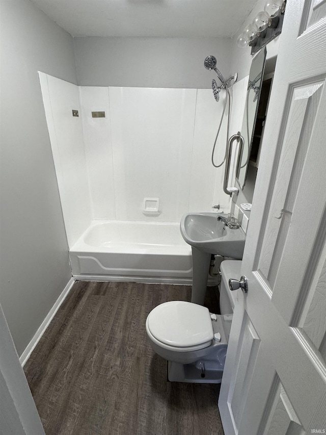 full bath with shower / bathing tub combination, wood finished floors, toilet, and baseboards