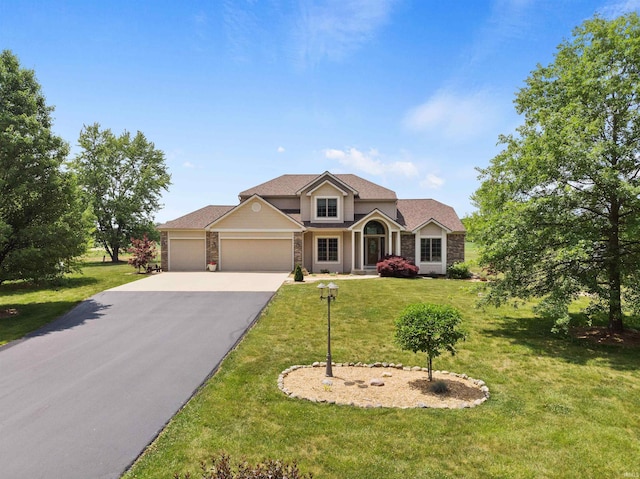 traditional home with a garage, driveway, and a front lawn