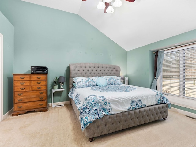 carpeted bedroom featuring lofted ceiling, visible vents, and baseboards