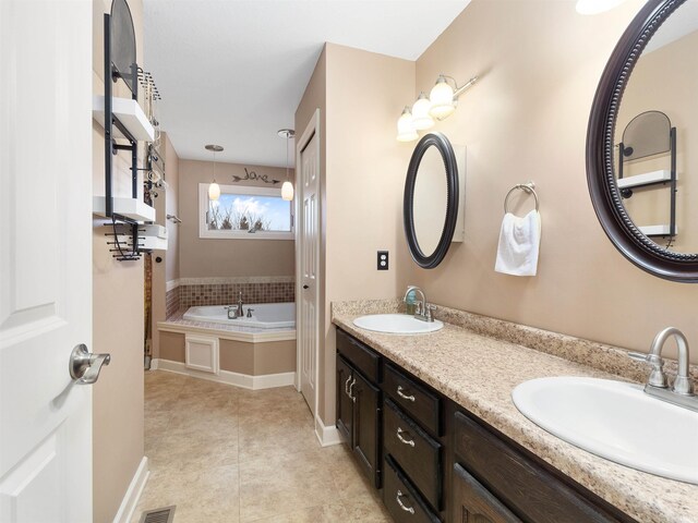 bathroom featuring tile patterned flooring, a garden tub, a sink, and double vanity