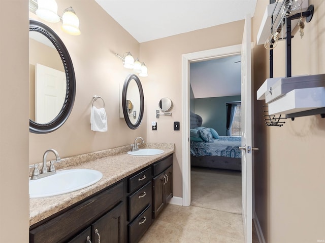 full bath featuring connected bathroom, tile patterned flooring, a sink, and double vanity