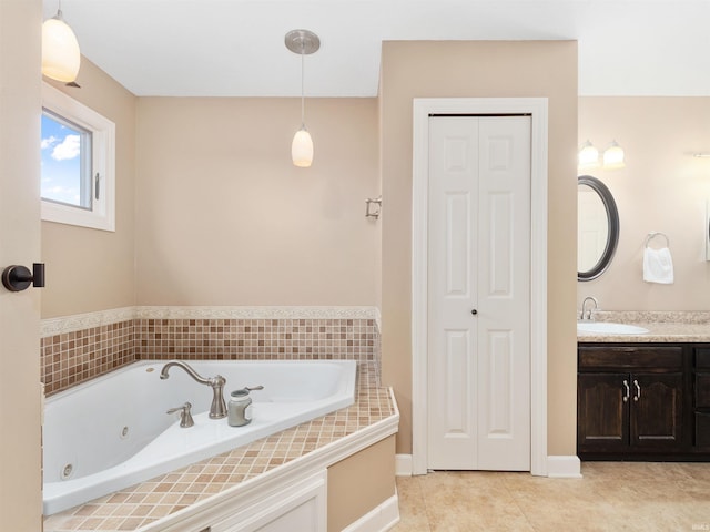 full bath with a whirlpool tub, tile patterned flooring, a closet, and vanity