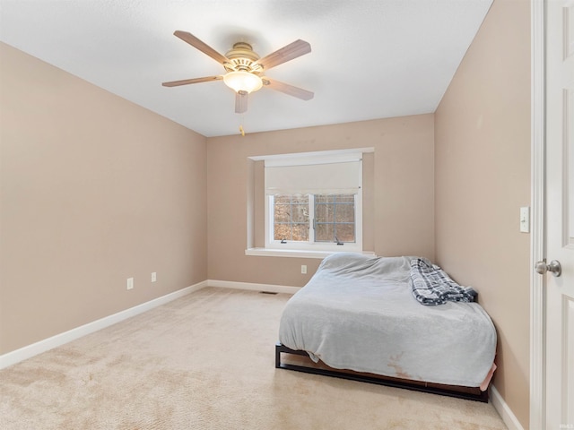 bedroom featuring carpet, baseboards, and a ceiling fan