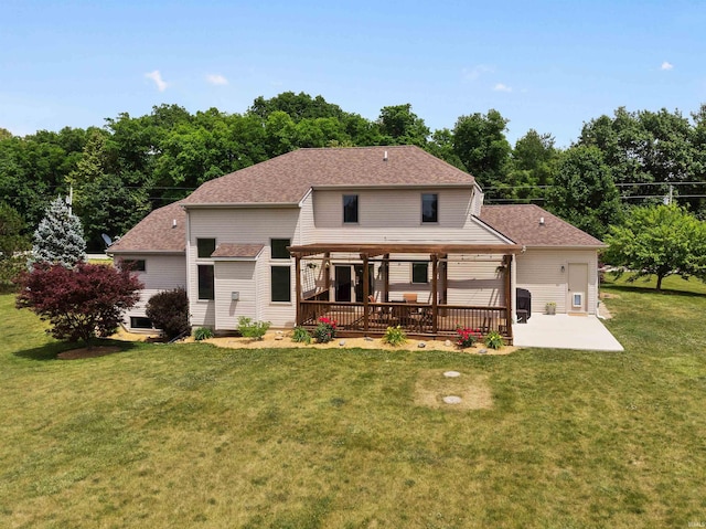 back of house featuring a patio, a lawn, and roof with shingles