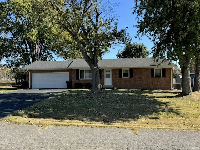 ranch-style home featuring aphalt driveway, brick siding, and a garage