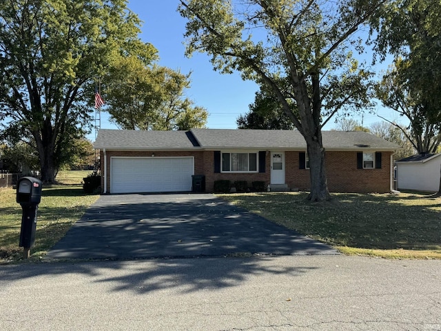 single story home featuring aphalt driveway, an attached garage, and brick siding