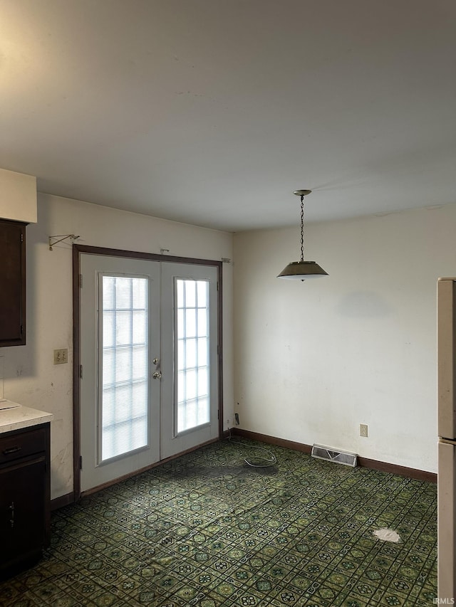 interior space with baseboards, visible vents, and french doors