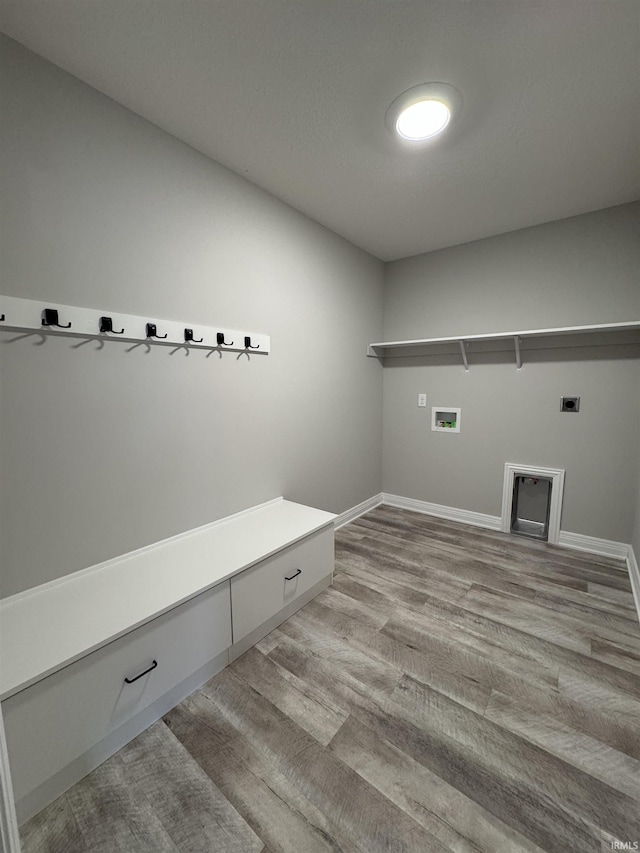 mudroom with light wood-type flooring and baseboards