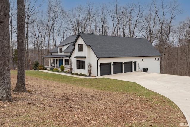 view of front of house with a garage, a shingled roof, driveway, board and batten siding, and a front yard