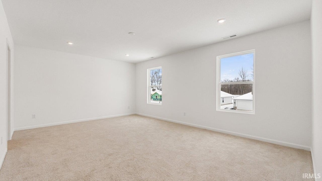 spare room with carpet floors and baseboards