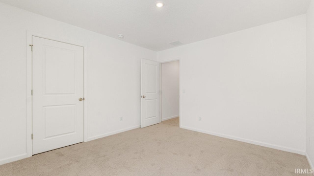 unfurnished bedroom featuring carpet floors and baseboards