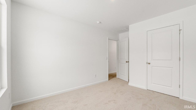 unfurnished bedroom with carpet and baseboards