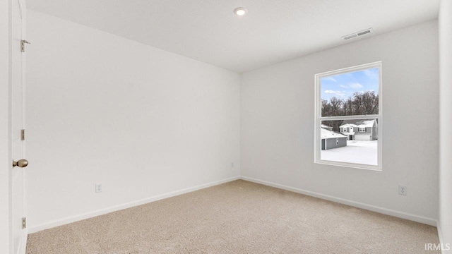 unfurnished room featuring baseboards, recessed lighting, visible vents, and light colored carpet