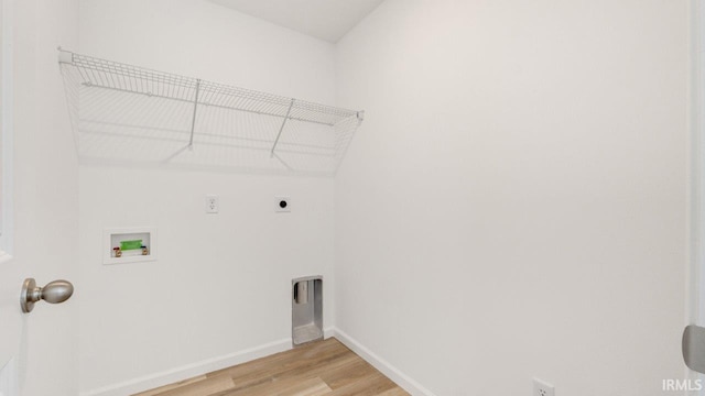 laundry area featuring hookup for a washing machine, light wood-style flooring, hookup for an electric dryer, laundry area, and baseboards