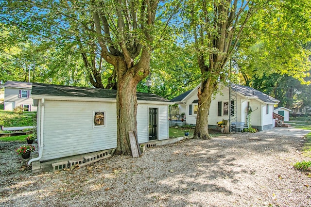 view of front of property featuring entry steps and an outbuilding