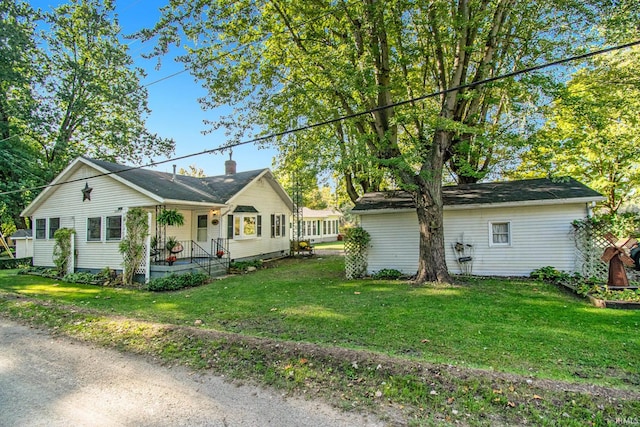 view of front of property featuring a chimney and a front lawn