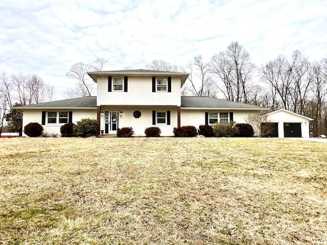 view of front of house with a front yard, an outdoor structure, and brick siding