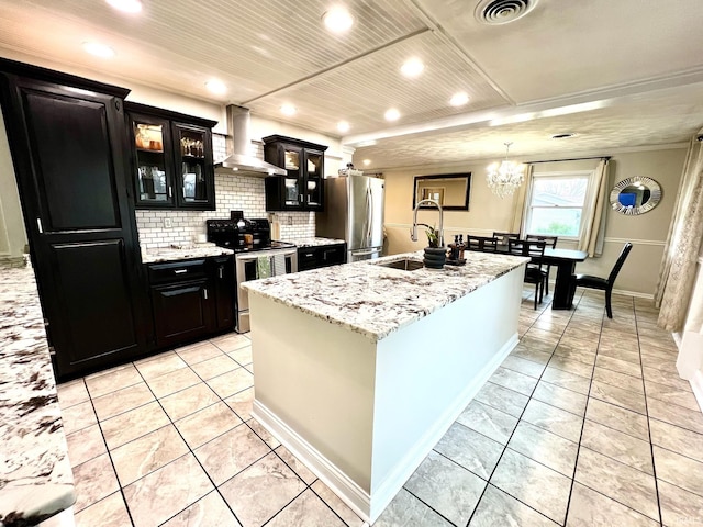 kitchen with stainless steel appliances, visible vents, light tile patterned flooring, a sink, and wall chimney exhaust hood