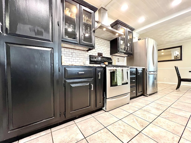 kitchen featuring stainless steel appliances, light tile patterned flooring, decorative backsplash, and wall chimney exhaust hood