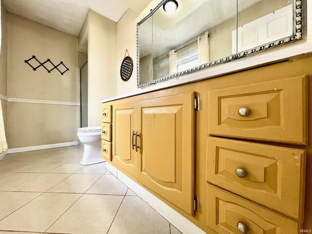 bathroom featuring baseboards, toilet, and tile patterned floors