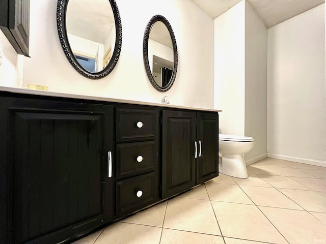 bathroom featuring vanity, tile patterned flooring, toilet, and baseboards