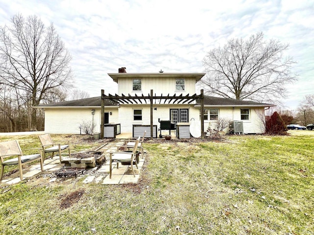 back of house featuring a patio, central air condition unit, a fire pit, a lawn, and a pergola