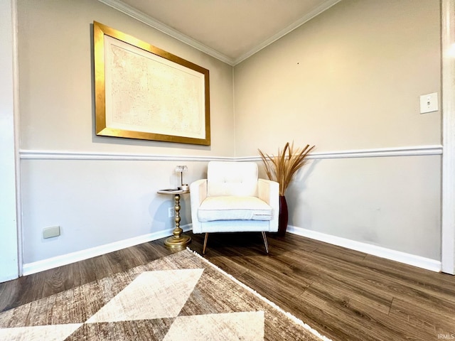 sitting room featuring baseboards, ornamental molding, and wood finished floors