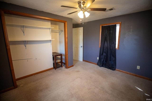 unfurnished bedroom featuring baseboards, visible vents, ceiling fan, carpet floors, and a closet