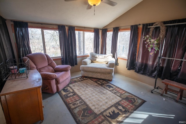 living area with lofted ceiling, a wealth of natural light, and a ceiling fan