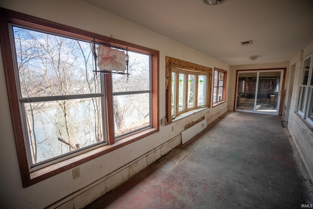 unfurnished sunroom with visible vents