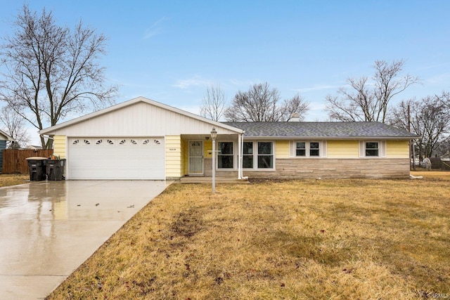 ranch-style house with an attached garage, fence, driveway, stone siding, and a front yard