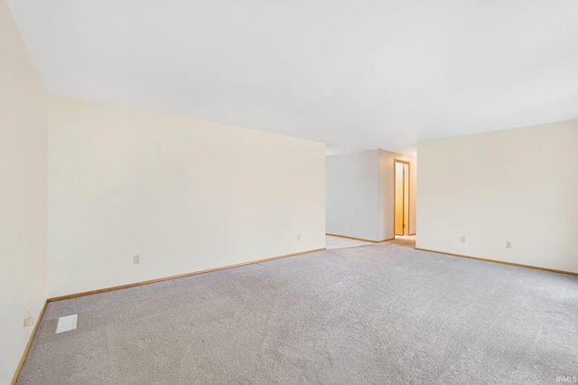 empty room with baseboards and light colored carpet