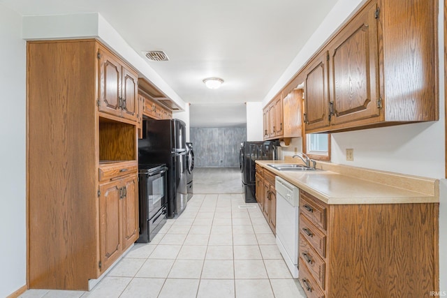 kitchen featuring light countertops, black range with electric stovetop, visible vents, white dishwasher, and a sink