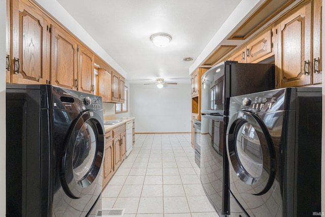 clothes washing area featuring light tile patterned floors, ceiling fan, laundry area, visible vents, and baseboards