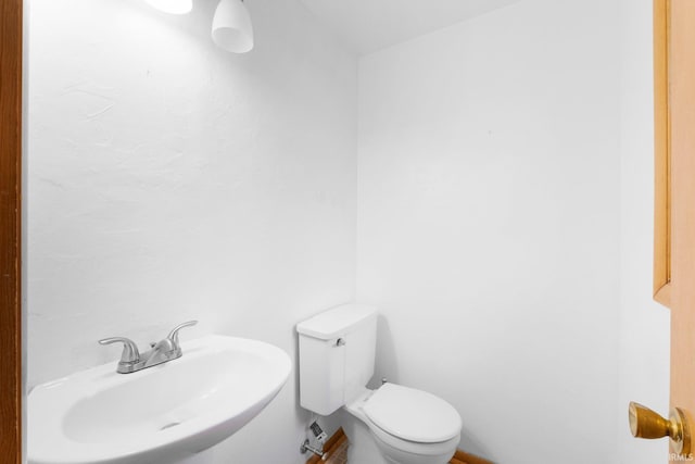 half bath with a sink and toilet