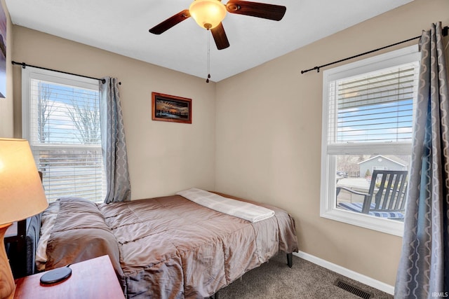 bedroom with multiple windows, carpet flooring, visible vents, and baseboards