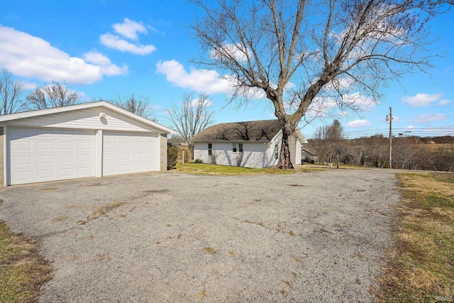 exterior space with a garage and an outdoor structure