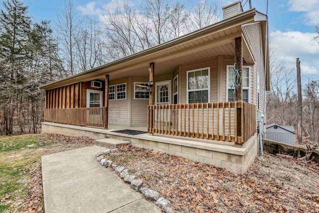 view of front of house featuring covered porch and a chimney