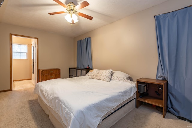 bedroom featuring a ceiling fan, baseboards, and light carpet