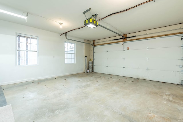 garage with a garage door opener and baseboards