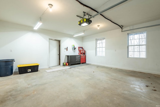 garage with a garage door opener and baseboards