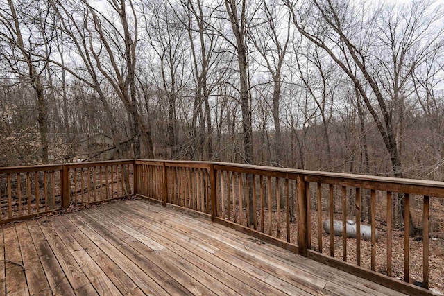 wooden deck with a view of trees