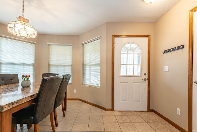 dining room with light tile patterned floors and baseboards