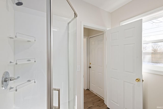 bathroom featuring a stall shower and wood finished floors