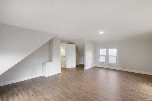 unfurnished living room with wood finished floors and baseboards