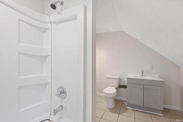 bathroom featuring a textured ceiling, shower / tub combination, tile patterned flooring, toilet, and vaulted ceiling